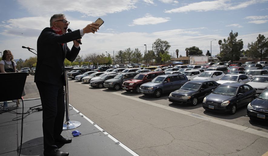In this file photo, Pastor Paul Marc Goulet speaks to people in their cars at an Easter drive-in service at the International Church of Las Vegas, Sunday, April 12, 2020, in Las Vegas. On Saturday, April 18, a Tennessee mayor confirmed he was reversing course and would allow drive-in church services during the coronavirus pandemic after his city was sued over its ban. (AP Photo/John Locher) **FILE**