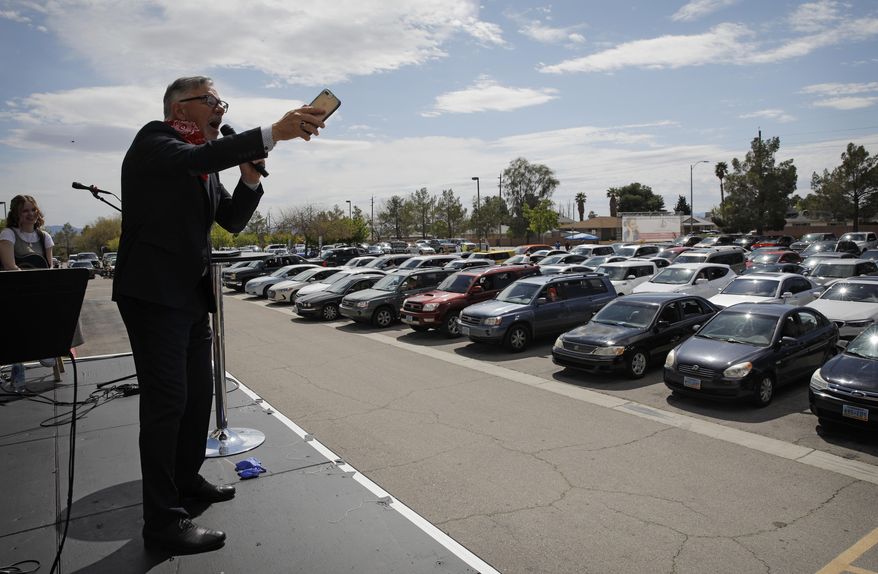 In this file photo, Pastor Paul Marc Goulet speaks to people in their cars at an Easter drive-in service at the International Church of Las Vegas, Sunday, April 12, 2020, in Las Vegas. On Saturday, April 18, a Tennessee mayor confirmed he was reversing course and would allow drive-in church services during the coronavirus pandemic after his city was sued over its ban. (AP Photo/John Locher) **FILE**