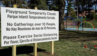 A sign announces the closing of a Omaha, Nebraska, playground. Nebraska is one of eight states without stay-at-home orders.