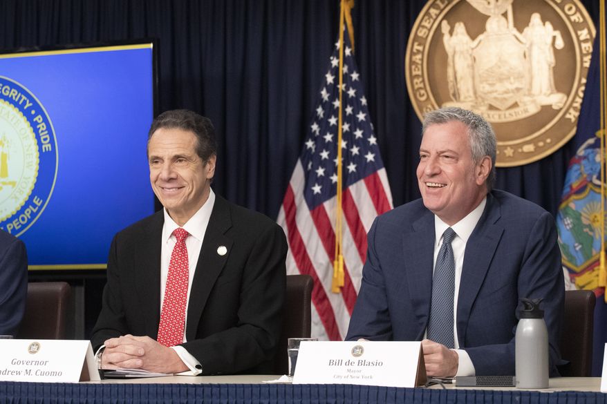 In this March 2, 2020 file photo New York Gov. Andrew Cuomo, left, and Mayor Bill de Blasio discuss the state and city's preparedness for the spread of coronavirus at a news conference in New York. (AP Photo/Mark Lennihan) **FILE**