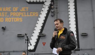 In this Nov. 15, 2019, photo U.S. Navy Capt. Brett Crozier, commanding officer of the aircraft carrier USS Theodore Roosevelt (CVN 71), addresses the crew during an all-hands call on the ship&#39;s flight deck while conducting routine operations in the Eastern Pacific Ocean. U.S. defense leaders are backing the Navy&#39;s decision to fire the ship captain who sought help for his coronavirus-stricken aircraft carrier, even as videos showed his sailors cheering him as he walked off the vessel. Videos went viral on social media Friday, April 3, 2020, showing hundreds of sailors gathered on the ship chanting and applauding Navy Capt. Brett Crozier as he walked down the ramp, turned, saluted, waved and got into a waiting car. (U.S. Navy Photo by Mass Communication Specialist 3rd Class Nicholas Huynh via AP)