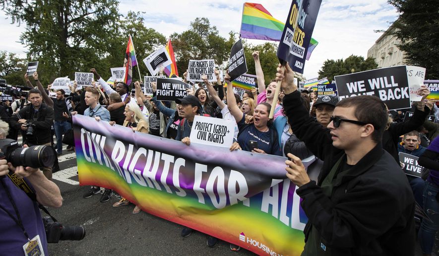 FILE - In this Oct. 8, 2019 file photo, supporters of LGBT rights stage a protest on the street in front of the U.S. Supreme Court in Washington. A group spearheading a ballot drive to add LGBT anti-discrimination protections to Michigan's civil rights law moved Monday, April 13, 2020, to collect voter signatures online because of the coronavirus pandemic. (AP Photo/Manuel Balce Ceneta,File)