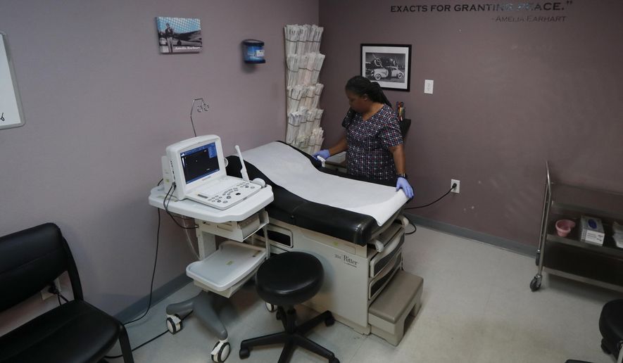 In this Sept. 4, 2019 file photo, Director of Clinical Services Marva Sadler, prepares the operating room at the Whole Woman's Health clinic in Fort Worth, Texas. On April 22, 2020, a federal court allowed Arkansas to ban most surgical abortions during the coronavirus pandemic.(AP Photo/Tony Gutierrez) **FILE**