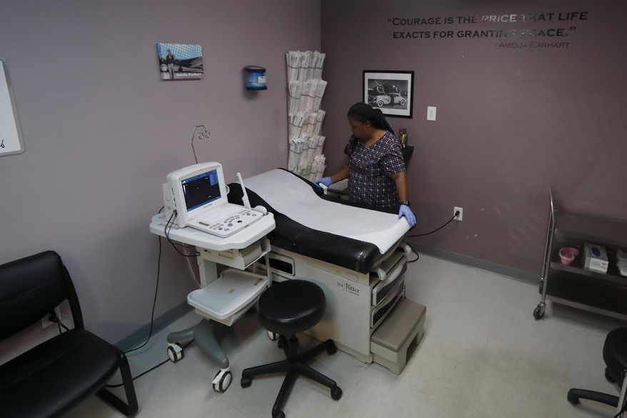 In this Sept. 4, 2019 file photo, Director of Clinical Services Marva Sadler, prepares the operating room at the Whole Woman's Health clinic in Fort Worth, Texas. On April 22, 2020, a federal court allowed Arkansas to ban most surgical abortions during the coronavirus pandemic.(AP Photo/Tony Gutierrez) **FILE**