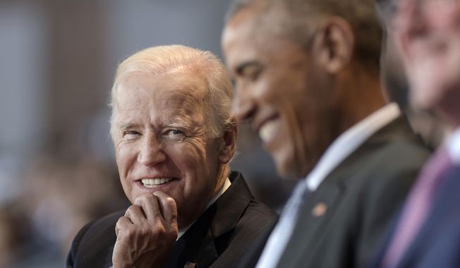 In this Jan. 4, 2017, file photo, then-Vice President Joe Biden, left, watches President Barack Obama, center, at Conmy Hall, Joint Base Myer-Henderson Hall, Va. (AP Photo/Susan Walsh) ** FILE **