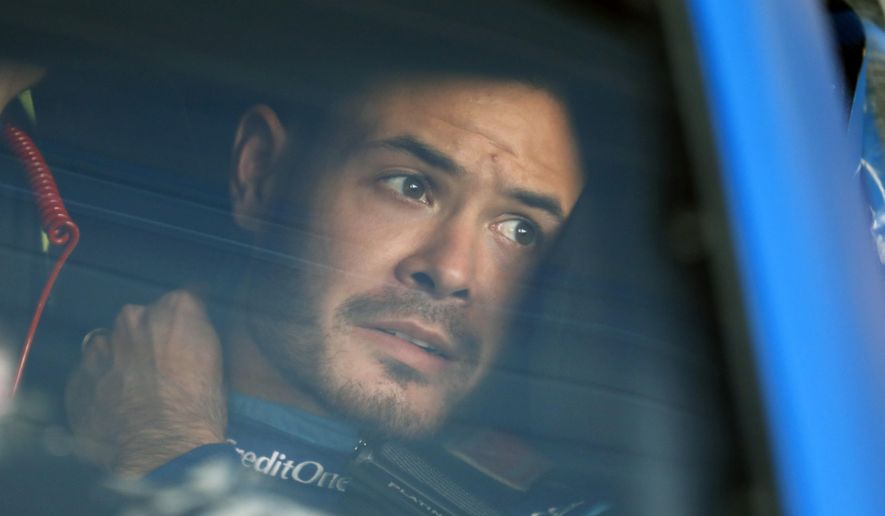 In this Oct. 18, 2019, file photo, Kyle Larson sits in his car before the final practice for a NASCAR Cup Series auto race at Kansas Speedway in Kansas City, Kan. Kyle Larson was fired Tuesday, April 14, 2020, by Chip Ganassi Racing, a day after nearly every one of his sponsors dropped the star driver for using a racial slur during a live stream of a virtual race. Larson, in his seventh Cup season with Ganassi and considered the top free agent in NASCAR mere weeks ago, is now stunningly out of a job in what could ultimately be an eight-figure blunder by the star.  (AP Photo/Colin E. Braley, File)  **FILE**