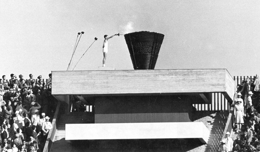 FILE - In this Oct. 10, 1964, file photo, Japanese runner Yoshinori Sakai lights the Olympic cauldron during the opening ceremony of the 1964 Summer Olympics in Tokyo. Sakai was born in Hiroshima on Aug. 6, 1945, the day the nuclear weapon destroyed that city. The 1964 Tokyo Olympics are being remembered fondly following the postponement until 2021 of the Tokyo 2020 Games. The &#39;64 Olympics were the first to be televised internationally using communication satellites. (AP Photo/File)