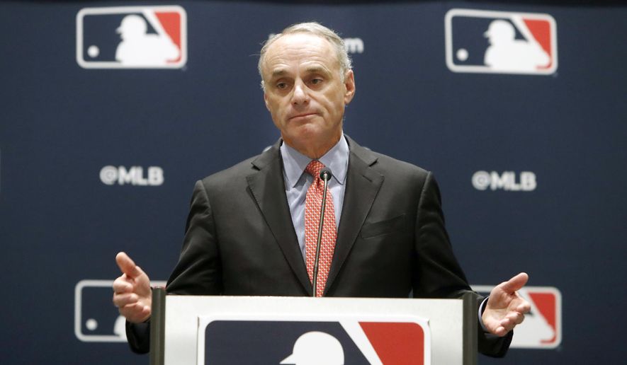 In this Nov. 21, 2019, file photo, baseball commissioner Rob Manfred speaks to the media at the owners meeting in Arlington, Texas. Major League Baseball is cutting the salary of senior staff by an average of 35% for this year and is guaranteeing paychecks to its full-time employees of its central office through May. Baseball Commissioner Rob Manfred made the announcement Tuesday, April 14, 2020.  (AP Photo/LM Otero, File)  **FILE**