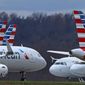 In this Tuesday, March 31, 2020, file photo, these are some of the 88 American Airlines planes stored at Pittsburgh International Airport in Imperial, Pa. (AP Photo/Gene J. Puskar, File)