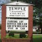 This image provided by Alliance Defending Freedom shows the sign for parking lot church services outside of Temple Baptist Church in Greenville, Miss., on April 9, 2020. The Justice Department has weighed in on a local Mississippi case involving a church that says its religious freedoms were violated. Temple Baptist in Greenville has been holding drive-in services for congregants during the coronavirus outbreak.  (Alliance Defending Freedom via AP)