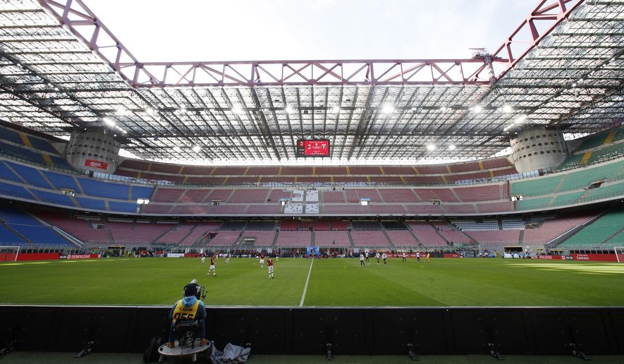 FILE - In this Sunday, March 8, 2020 filer, a view of the empty stadium during the Serie A soccer match between AC Milan and Genoa at the San Siro stadium, in Milan, Italy. While soccer leagues around Europe are still debating whether and when to resume playing, the leader of the continent’s Federation of Sports Medicine Associations is calling for a detailed series of tests to clear athletes for a return to training. Maurizio Casasco, who is also president of the Italian Federation of Sports Medicine, said that guidelines recently published by his domestic federation should be extended for all of Europe -- especially if UEFA intends to resume the Champions League and Europa League anytime soon. (AP Photo/Antonio Calanni, File)