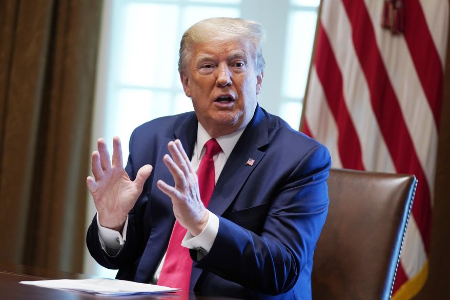 President Donald Trump speaks during a meeting with people that have recovered from COVID-19, in the Cabinet Room of the White House, Tuesday, April 14, 2020, in Washington. (AP Photo/Evan Vucci)