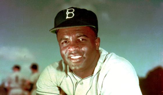 In this 1952 file photo, Brooklyn Dodgers baseball player Jackie Robinson poses. Forced from the field by the new coronavirus, Major League Baseball is moving its annual celebration of Jackie Robinson online. The Jackie Robinson Foundation is launching a virtual learning hub to coincide with the 73rd anniversary Wednesday, April 15, 2020, of Robinson breaking the major league color barrier. (AP Photo/File)  **FILE**