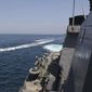 In this Wednesday, April 15, 2020, photo made available by U.S. Navy, Iranian Revolutionary Guard vessels sail close to U.S. military ships in the Persian Gulf near Kuwait. (U.S. Navy via AP) **FILE**