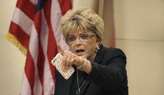 In this Nov. 6, 2019 file photo Las Vegas Mayor Carolyn Goodman points toward protesters during the council meeting where the city council was considering a ban on homeless camping in Las Vegas. The morning after Nevada Gov. Steve Sisolak declared he was nowhere near reopening parts of the state&#39;s idled economy.Goodman said &amp;quot;I am asking: Open the city. Open Clark County. Open the state,&amp;quot; (Bizuayehu Tesfaye /Las Vegas Review-Journal via AP,File)