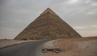 This March 30, 2020 photo, shows the empty Giza Pyramids on lockdown due to the coronavirus outbreak in Egypt.  (AP Photo/Nariman El-Mofty)