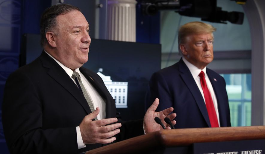 President Donald Trump listens as Secretary of State Mike Pompeo speaks about the coronavirus in the James Brady Press Briefing Room of the White House, Wednesday, April 8, 2020, in Washington. (AP Photo/Alex Brandon)