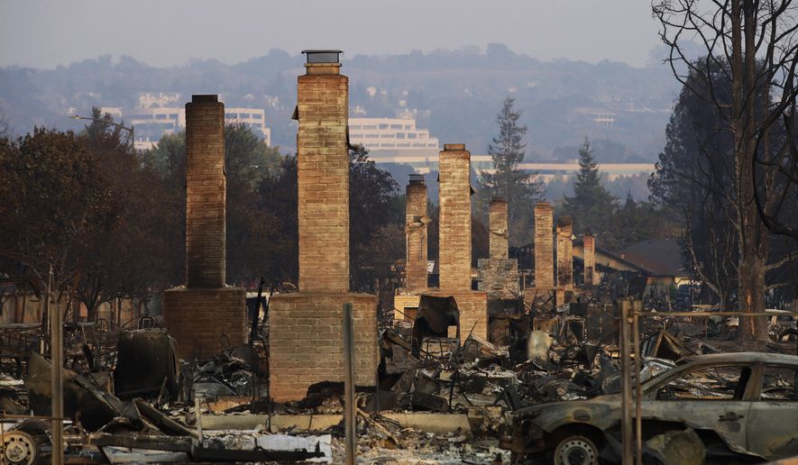 FILE - This Oct. 13, 2017 file photo shows a row of chimneys standing in a neighborhood devastated by the Tubbs fire near Santa Rosa, Calif. Pacific Gas & Electric will face another legal challenge to a $13.5 billion settlement with more than 80,000 Northern California victims worried they're being shortchanged in a deal that's supposed to repay them for losses caused by the utility's negligence. (AP Photo/Jae C. Hong, File)