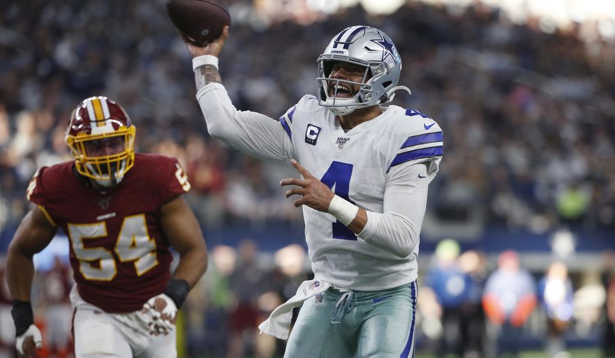 FILE - In this Dec. 15, 2019, file photo, Dallas Cowboys quarterback Dak Prescott (4) delivers a touchdown pass to running back Ezekiel Elliott during the first half of an NFL football game against the Washington Redskins in Arlington, Texas. The two biggest losses in free agency for the Dallas Cowboys were at cornerback and defensive end, so it's reasonable to list those as the club's top two priorities going into the draft. (AP Photo/Ron Jenkins, File)
