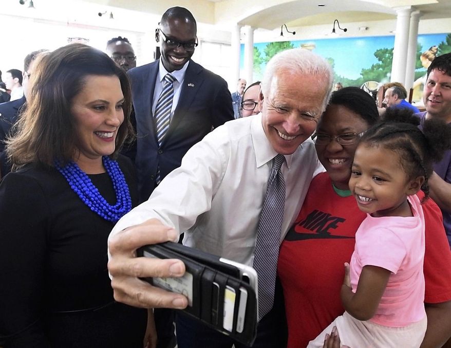 In this Sept. 12, 2018, Former Vice President Joe Biden takes a photo with Samantha Green and daughter Ava Green during a visit with Michigan Democratic gubernatorial candidate Gretchen Whitmer, left, and running mate Garland Gilchrist to Leo's Coney Island in Southfield, Mich. As presumptive Democratic presidential nominee Joe Biden begins the process of choosing a running mate amid the coronavirus crisis, managing the pandemic has become its own version of an audition. For potential picks, lobbying for the job means breaking into the national conversation, positioning themselves as leaders and executing at their day job. (Daniel Mears/Detroit News via AP) **FILE**