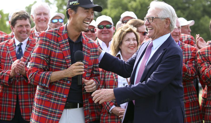 FILE - In this May 26, 2019, file photo, Kevin Na, front left, is congratulated by Charles Schwab after winning The Charles Schwab Challenge at Colonial in Fort Worth, Texas. The PGA Tour laid out an ambitious plan to resume its season Thursday, April 16, 2020, with hopes of a restart at Colonial on June 11-14 and keeping fans away for at least the first month. (AP Photo/ Richard W. Rodriguez, File)
