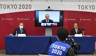Tokyo 2020 Organizing Committee President Yoshiro Mori, left, and CEO Toshiro Muto, right, attend teleconference with International Olympic Committee member John Coates, who heads the inspection team for Tokyo Olympics, in Tokyo Thursday, April 16, 2020. Tokyo Olympic organizers and the IOC said Thursday they will cut some of the extras out of next year’s postponed games, an attempt to limit what is expected to be billions of dollars in added expenses.(Kazuhiro Nogi/Pool Photo via AP)