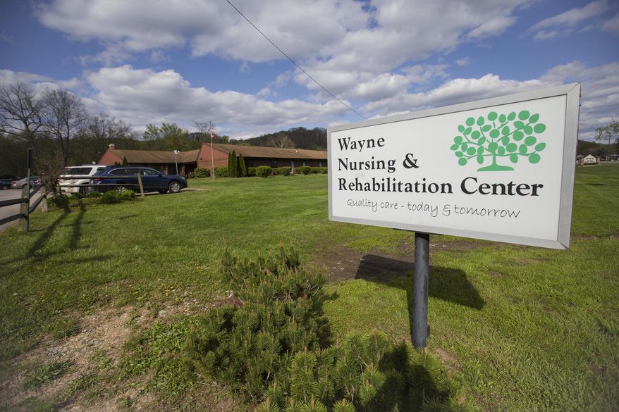 This April 10, 2020 photo shows the Wayne Nursing and Rehabilitation Center in Wayne, Ind. The West Virginia nursing home already linked to a coronavirus death is now reporting an outbreak of 66 new cases. At least 36 residents and 30 staffers of the Wayne Nursing and Rehabilitation Center have the virus, according to a statement posted on the facility's social media late Monday, April 13, 2020. Ten tests are still pending. (Sholten Singer/The Herald-Dispatch via AP)