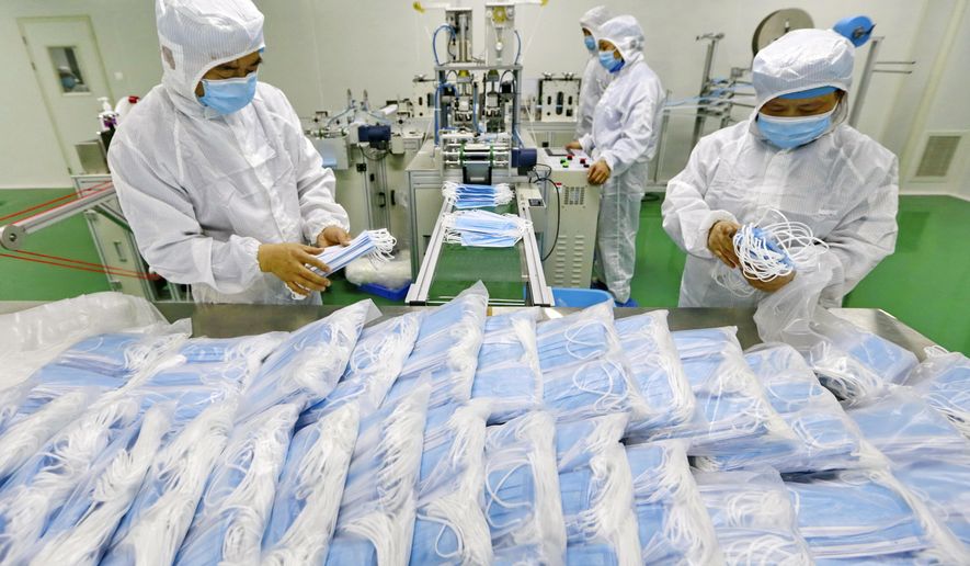 FILE - In this Feb. 7, 2020 file photo, workers pack surgical masks at a factory in Suining city in southwest China's Sichuan province. China won't restrict exports of medical goods needed to fight the coronavirus pandemic, a government spokesman said Thursday, April 16, 2020, amid global tension over scarce masks and ventilators. (Chinatopix via AP, File)
