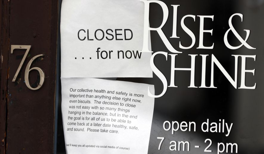 A closed sign hangs in the window of a coffee house since a statewide stay-at-home order was put into effect to stop the spread of the new coronavirus Thursday, April 16, 2020, in Denver. The new coronavirus causes mild or moderate symptoms for most people, but for some, especially older adults and people with existing health problems, it can cause more severe illness or death. (AP Photo/David Zalubowski)