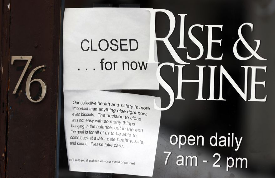 A closed sign hangs in the window of a coffee house since a statewide stay-at-home order was put into effect to stop the spread of the new coronavirus Thursday, April 16, 2020, in Denver. The new coronavirus causes mild or moderate symptoms for most people, but for some, especially older adults and people with existing health problems, it can cause more severe illness or death. (AP Photo/David Zalubowski)