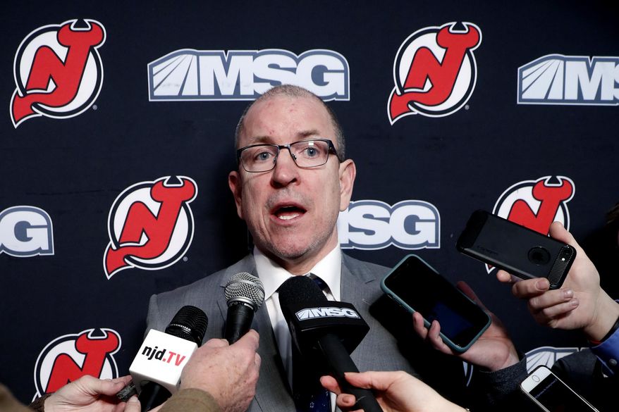FILE - In this Feb. 16, 2020, file photo, New Jersey Devils interim general manager Tom Fitzgerald answers reporters&#39; questions after the team announced that captain Andy Greene was traded to the New York Islanders before an NHL hockey game in Newark, N.J. The suspension of play in the NHL because of the coronavirus pandemic has put Fitzgerald of the Devils is limbo. The 51-year-old is waiting to see if the league will finish its season and also see if he still has a job. (AP Photo/Kathy Willens, File)