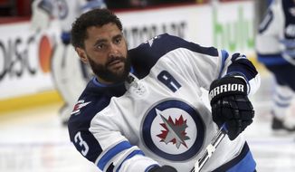 FLE - In this April 17, 2018, file photo, Winnipeg Jets&#39; Dustin Byfuglien warms up before Game 4 of an NHL hockey first-round playoff series against the Minnesota Wild in St. Paul, Minn. The Winnipeg Jets and Dustin Byfuglien have agreed to mutually terminate his contract after a lengthy dispute. (AP Photo/Jim Mone, File)