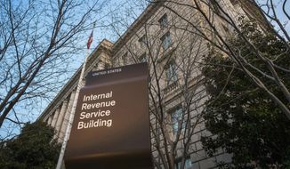 This April 13, 2014, file photo shows the Internal Revenue Service (IRS) headquarters building in Washington. On Friday, April 17, 2020, The Associated Press reported on stories circulating online incorrectly asserting that one can call a 1-800 number and enter your social security number to check on the status of the relief check the federal government is sending as part of the $2.2 trillion economic recovery bill in response to the coronavirus. The IRS isn’t currently accepting calls by phone because of the coronavirus. The IRS has warned Americans of scam artists who might try to swindle you out of your relief check through fraudulent emails, text messages, websites or social media posts that request your banking or personal information. (AP Photo/J. David Ake, File  **FILE**