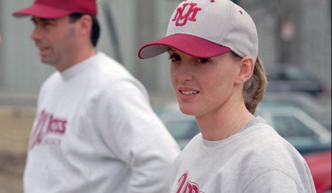 FILE - In this Wednesday, Feb. 28, 1995, file photo, University of Massachusetts assistant baseball coach Julie Croteau watches the team during practice in Amherst, Mass. At left is coach Mike Stone. Julie Croteau sometimes felt alone along her historic path as a female baseball player. That changed the day she set foot on the set of the Penny Marshall-directed movie “A League of Their Own.” The film checked in at No. 10 on The Associated Press best sports movies Top 25. (AP Photo/David Bruneau, File)