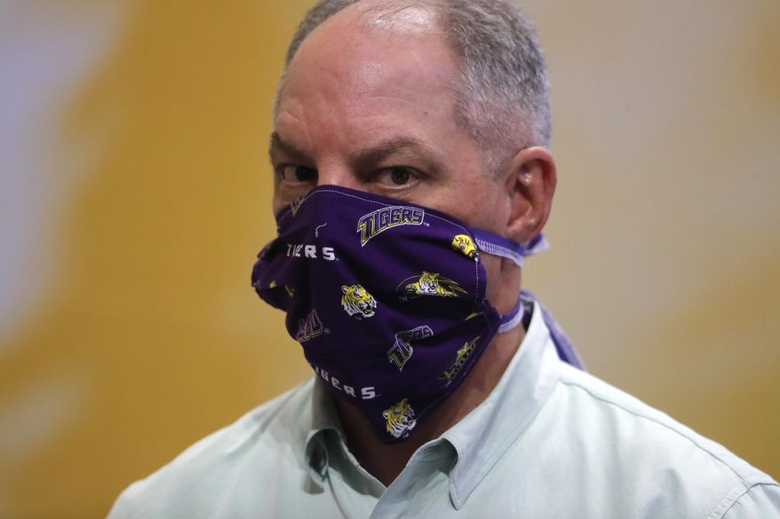 Louisiana Gov. John Bel Edwards wears a face mask as he visits a production site on the LSU campus in Baton Rouge, La., where the school is manufacturing personal protection equipment for hospitals in response to the coronavirus pandemic Friday, April 17, 2020. (AP Photo/Gerald Herbert)