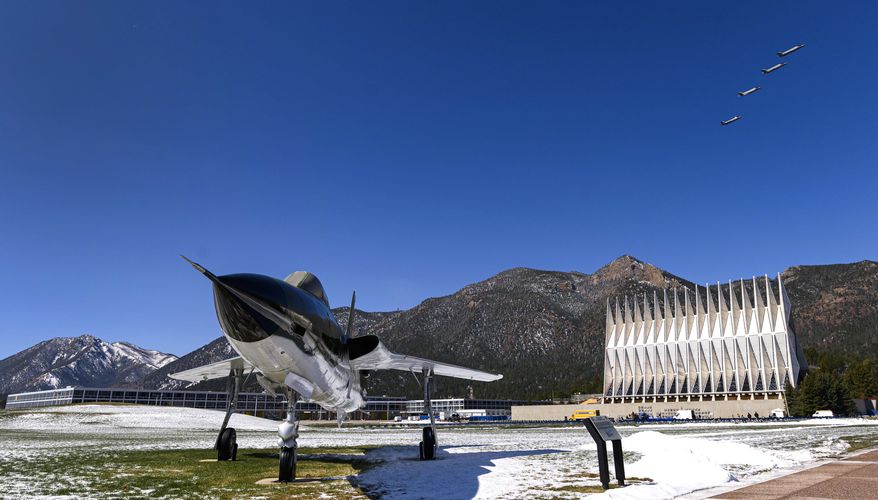 Four F-35A fighter jets fly over the Air Force Academy in Colorado Springs, Colo., Friday, April 17, 2020, to honor the Class of 2020 who will graduate early in a closed ceremony Saturday on the terrazzo at the center of campus rather than Falcon Stadium. The early graduation on the terrazzo will allow them to stay 8 feet apart during the COVID-19 pandemic. Vice President Mike Pence will speak in person, but the cadets won&#x27;t march up to receive diplomas and high fives and hugs are banned. The Thunderbirds will fly over at the conclusion of the ceremony that will be streamed online for families and friends. In the foreground is a Republic F-105D Thunderchief, the first supersonic tactical fighter-bomber developed from scratch. The first F-105D Thunderchief flew in 1959 and played a major role in the Vietnam War. (Christian Murdock/The Gazette via AP)