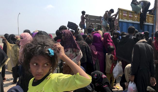 Rohingya refugees gather after being rescued in Teknaf near Cox&#x27;s Bazar, Bangladesh, Thursday, April 16, 2020. Bangladesh&#x27;s coast guard has rescued 382 starving Rohingya refugees who had been drifting at sea for weeks after failing to reach Malaysia, officials said Thursday. (AP Photo/Suzauddin Rubel)