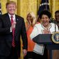 In this April 1, 2019, file photo, President Donald Trump reacts as Alice Marie Johnson speaks at the 2019 Prison Reform Summit and First Step Act Celebration in the East Room of the White House in Washington. The 64-year-old African American great-grandmother spent 21 years in prison for a nonviolent drug offense before Trump commuted her sentence in 2018. (AP Photo/Andrew Harnik, File)