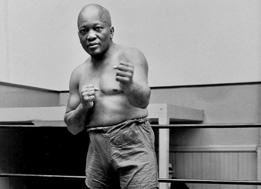 FILE - In this 1932 file photo, boxer Jack Johnson, the first black world heavyweight champion, poses in New York City. Born on March 31, 1878, Johnson was the first black world heavyweight boxing champion, holding the title from 1908 to 1915. He remains a boxing legend, with his 1910 fight against James J. Jeffries dubbed the &amp;quot;fight of the century&amp;quot;. (AP Photo/File)