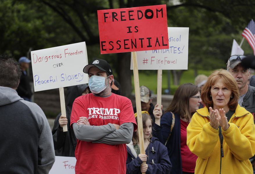 Protesters rally at the Texas State Capitol to speak out against Texas' handling of the COVID-19 outbreak, in Austin, Texas, Saturday, April 18, 2020. Austin and many other Texas cities remain under stay-at-home orders due to the COVID-19 outbreak except for essential personal. (AP Photo/Eric Gay)