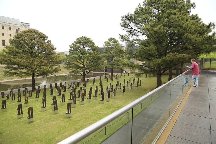 A man pauses at 9:02 a.m. at the overlook on the plaza outside the Oklahoma City National Memorial and Museum on the 25th anniversary of the bombing of the Alfred P. Murrah Federal Building in Oklahoma City, Sunday, April 19, 2020. The memorial remains closed and did not hold a live remembrance ceremony due to coronavirus restrictions. (Doug Hoke/The Oklahoman via AP)