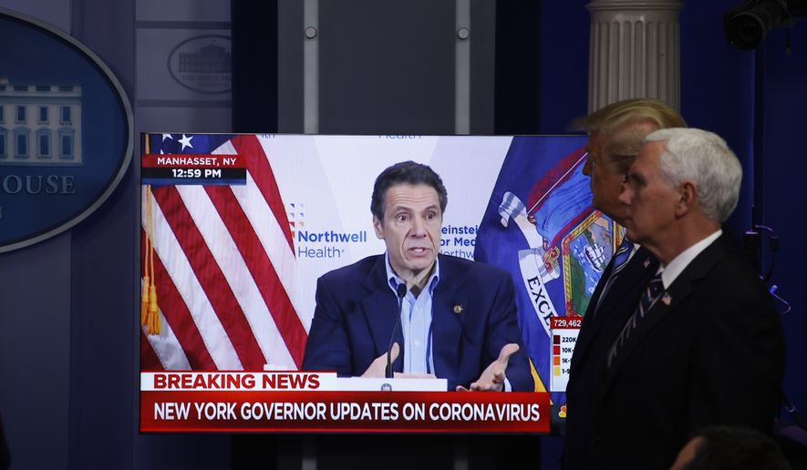 Vice President Mike Pence, right, and President Donald Trump watch a video of New York Gov. Andrew Cuomo speaking during a coronavirus task force briefing at the White House, Sunday, April 19, 2020, in Washington. (AP Photo/Patrick Semansky)