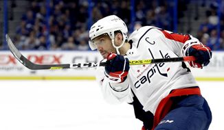 In this Dec. 14, 2019, file photo, Washington Capitals left wing Alex Ovechkin follows through on a shot against the Tampa Bay Lightning during the first period of an NHL hockey game in Tampa, Fla. Possibly losing as many as 13 games with the NHL on hold because of the coronavirus pandemic could leave Ovechkin two short of another 50-goal season and threaten his ability to break Wayne Gretzky’s all-time record. (AP Photo/Chris O&#39;Meara) ** FILE **
