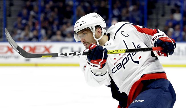 In this Dec. 14, 2019, file photo, Washington Capitals left wing Alex Ovechkin follows through on a shot against the Tampa Bay Lightning during the first period of an NHL hockey game in Tampa, Fla. Possibly losing as many as 13 games with the NHL on hold because of the coronavirus pandemic could leave Ovechkin two short of another 50-goal season and threaten his ability to break Wayne Gretzky’s all-time record. (AP Photo/Chris O&#x27;Meara) ** FILE **
