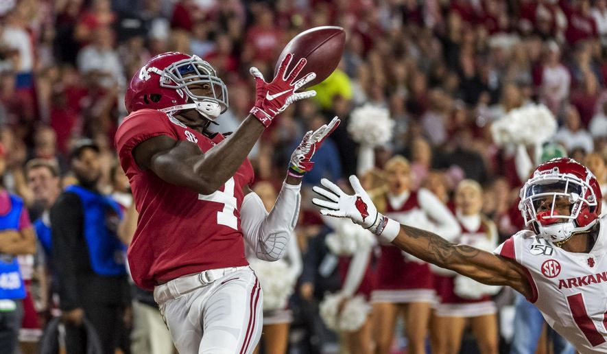 FILE - In this Oct. 26, 2019, file photo, Alabama wide receiver Jerry Jeudy (4) catches a touchdown pass against Arkansas during the second half of an NCAA college football game in Tuscaloosa, Ala. This year’s NFL draft features a superb group of wide receivers, including Jeudy, who are expected to make immediate impacts in the NFL. (AP Photo/Vasha Hunt, File)