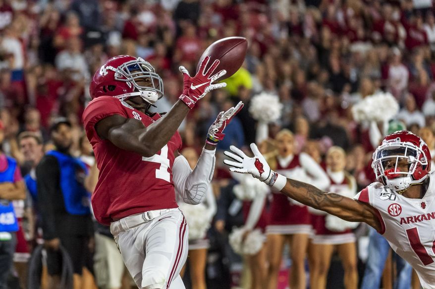 FILE - In this Oct. 26, 2019, file photo, Alabama wide receiver Jerry Jeudy (4) catches a touchdown pass against Arkansas during the second half of an NCAA college football game in Tuscaloosa, Ala. This year’s NFL draft features a superb group of wide receivers, including Jeudy, who are expected to make immediate impacts in the NFL. (AP Photo/Vasha Hunt, File)