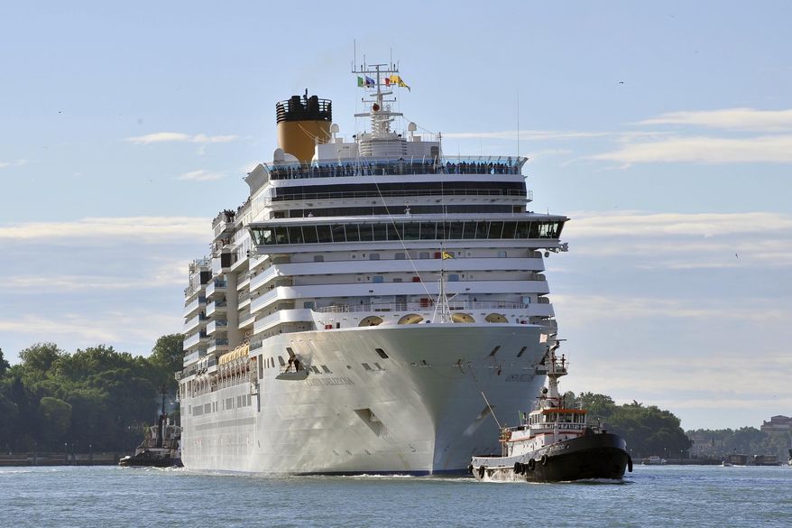 In this photo taken on Sunday, May 24, 2015, the Costa Deliziosa cruise ship leaves Venice, Italy. Passengers on a luxury liner's around-the-world cruise, which began before the globe was gripped by the coronavirus pandemic, are finally approaching their odyssey's end after 15 weeks at sea. Next week, the Costa Deliziosa is due to reach Spain and Italy, two of the countries most devastated by COVID-19 infections. (AP Photo/Luigi Costantini)