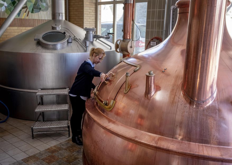 In this , Friday, April 17, 2020 photo junior director Christine Lang of the "Wernecker brewery" stands in the brewhouse of the brewery in Werneck, Germany. Due to the impact of the coronavirus the traditional brewery has to close 400 years after its foundation. (AP Photo/Michael Probst)