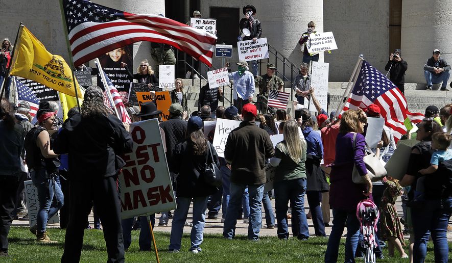 Protesters gather outside of the Ohio State House in Columbus, Ohio on April 20, 2020, to protest the stay home order that is in effect until May 1. (AP Photo/Gene J. Puskar)