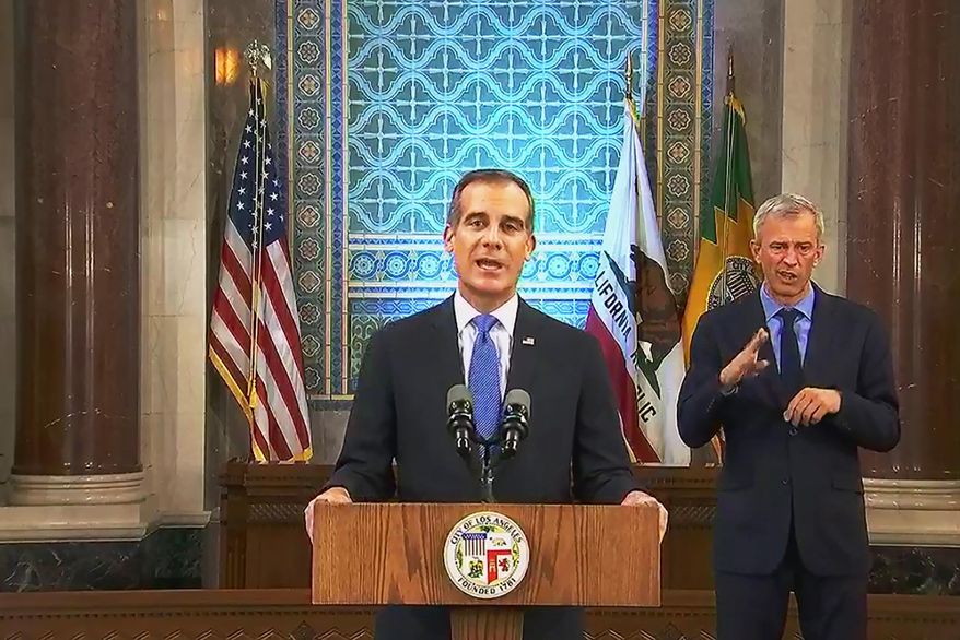 This photo from streaming video provided by the Office of Mayor Eric Garcetti shows Los Angeles Mayor Eric Garcetti giving his annual State of the City speech in an otherwise empty City Hall council chamber Sunday, April 19, 2020. He said thousands of Los Angeles city workers must take 26 furlough days, the equivalent of a 10 percent pay cut, over the course of the next fiscal year as the nation&#39;s second-largest city deals with the economic fallout from the COVID-19 crisis. Garcetti warned of an economic blow far worse than the 2008 recession, when city leaders laid off hundreds of workers and eliminated thousands of jobs. (Office of Mayor Eric Garcetti via AP)
